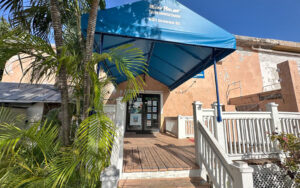front exterior entrance with blue awning at reef relief environmental center key west