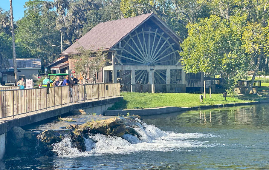 mill house with cataract and viewers along bridge at de leon springs