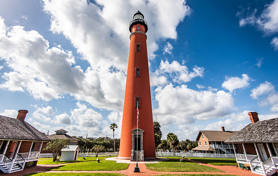 red painted ponce de leon inlet lighthouse and museum grounds